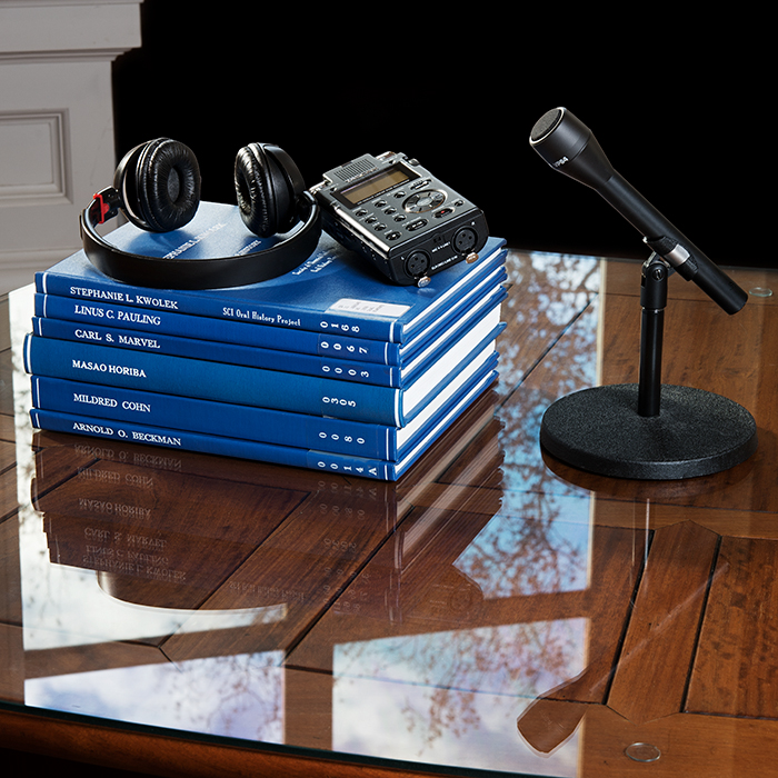 Oral History - stack of books and microphone on table