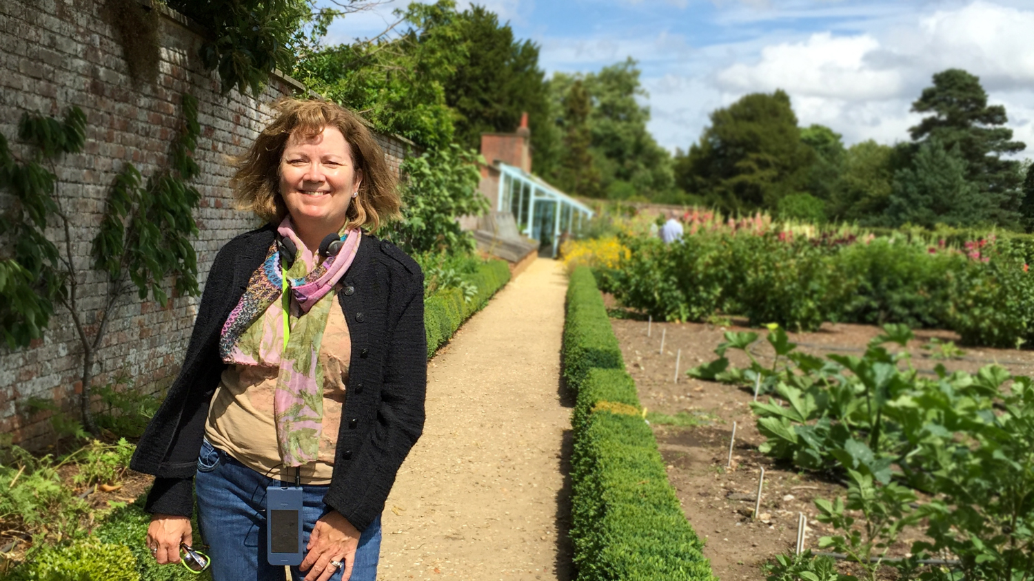 Jean Ristaino stands next to potato plots in the backyard of Down House, Charles Darwin's home.