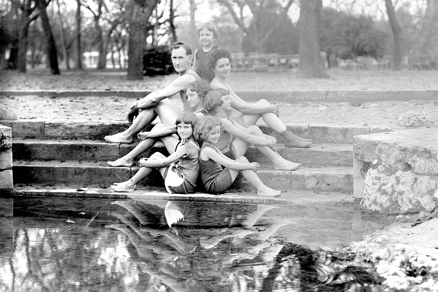 American Eugenics Society photograph of winner in Large Family Class, Texas State Fair, 1925. Parents and five children. Family posed in bathing suits, back to back.